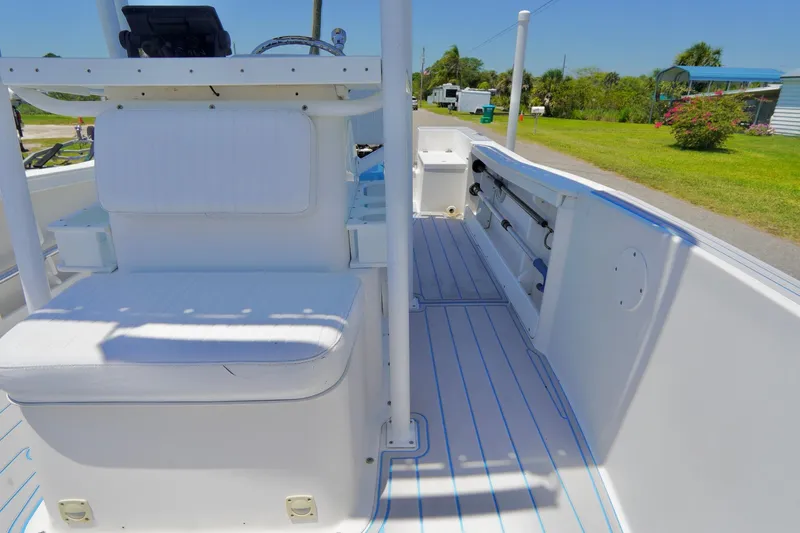 Slide: The Image of 2003 Key Largo 186 CC boat interior with white seating and rod holders. - 8