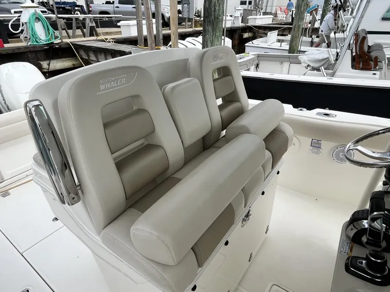 Slide: The Image of 2018 Boston Whaler 330 Outrage boat seating area with luxurious beige upholstery. - 17