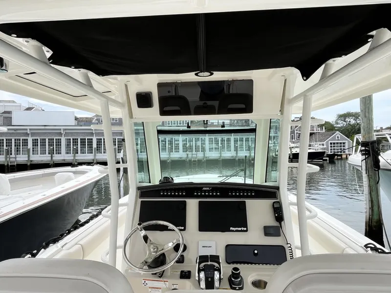 Slide: The Image of 2018 Boston Whaler 330 Outrage boat cockpit with modern navigation equipment, docked at marina. - 21