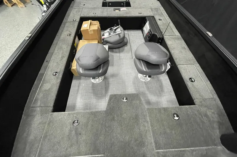 Slide: The Image of 2026 Alumacraft Competitor 185X Tiller interior with two seats and storage compartments. - 10