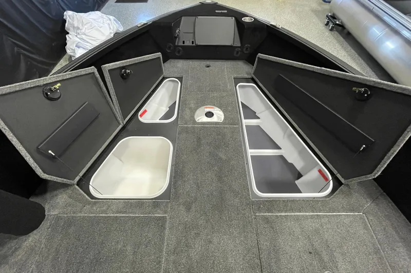 Slide: The Image of 2026 Alumacraft Competitor 185X Tiller boat interior with open storage compartments. - 12