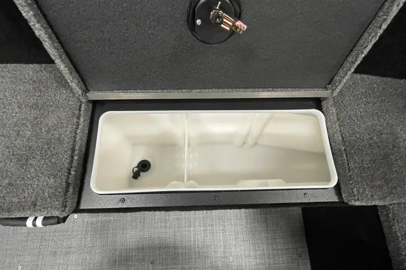 Slide: The Image of 2026 Alumacraft Competitor 185X Tiller livewell compartment, open and empty. - 14