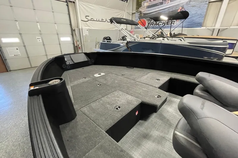 Slide: The Image of 2026 Alumacraft Competitor 185X Tiller boat interior with seating and storage compartments. - 5