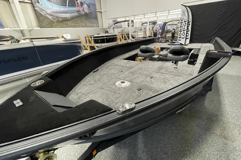 Slide: The Image of 2026 Alumacraft Competitor 185X Tiller boat displayed indoors, featuring spacious deck and seating. - 6