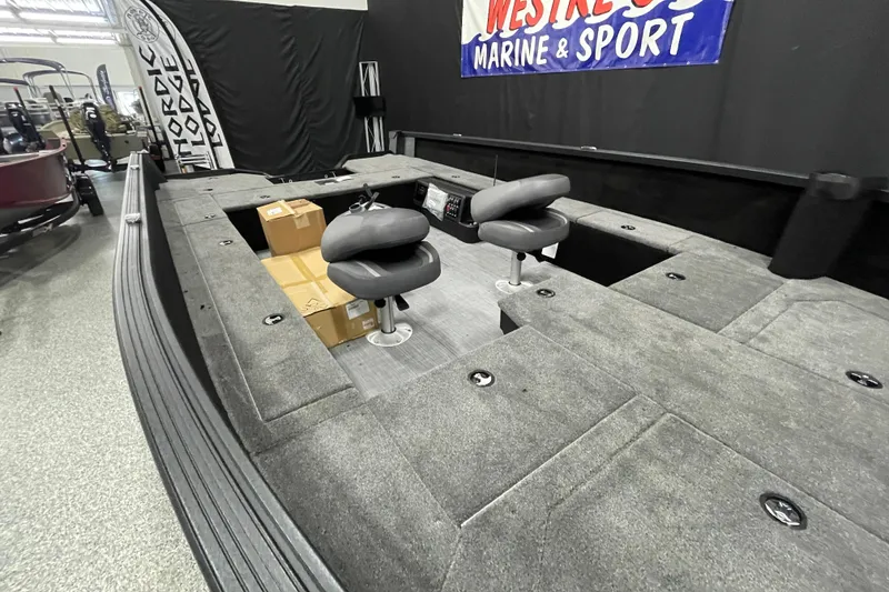 Slide: The Image of 2026 Alumacraft Competitor 185X Tiller boat interior with seating and storage compartments. - 7