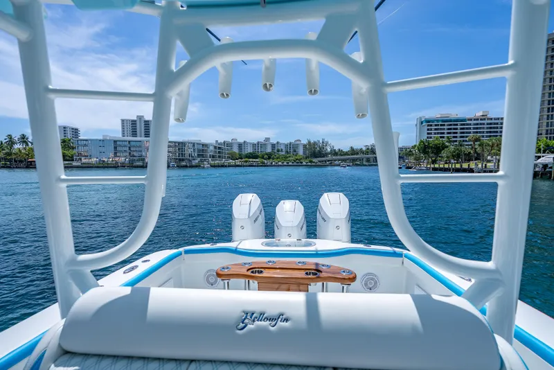 Slide: The Image of 2016 Yellowfin 39 Offshore boat with triple engines, scenic waterfront view, and modern cityscape backdrop. - 10