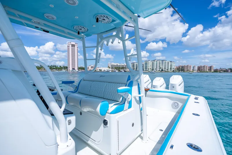 Slide: The Image of 2016 Yellowfin 39 Offshore boat interior with blue accents, ocean view, and city skyline. - 12