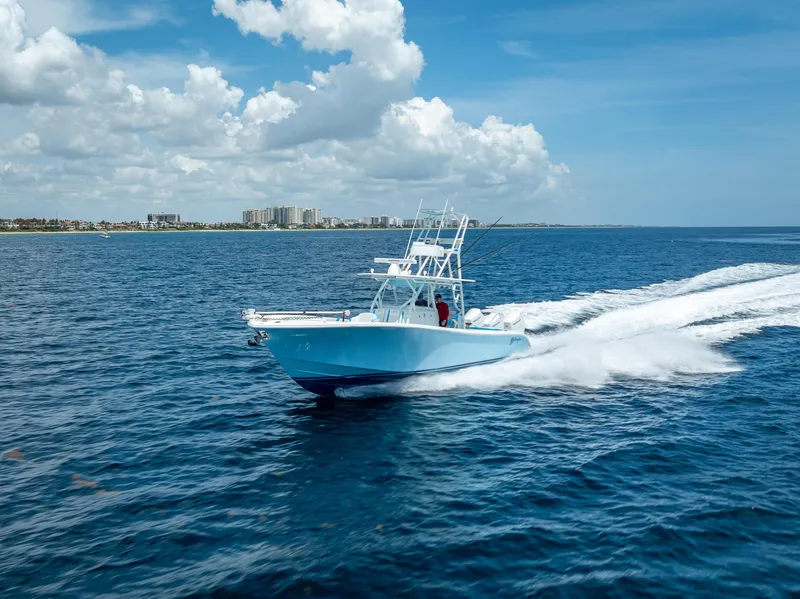 Slide: The Image of 2016 Yellowfin 39 Offshore boat cruising on open ocean under blue sky. - 2