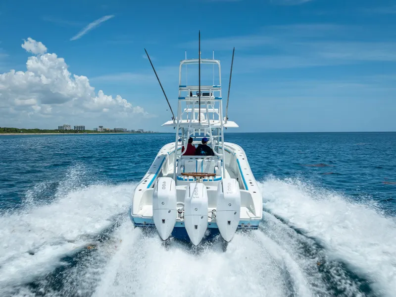 Slide: The Image of 2016 Yellowfin 39 Offshore boat cruising on open ocean under clear blue sky. - 5