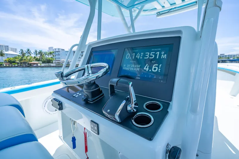Slide: The Image of 2016 Yellowfin 39 Offshore boat dashboard with navigation display and steering wheel. - 9