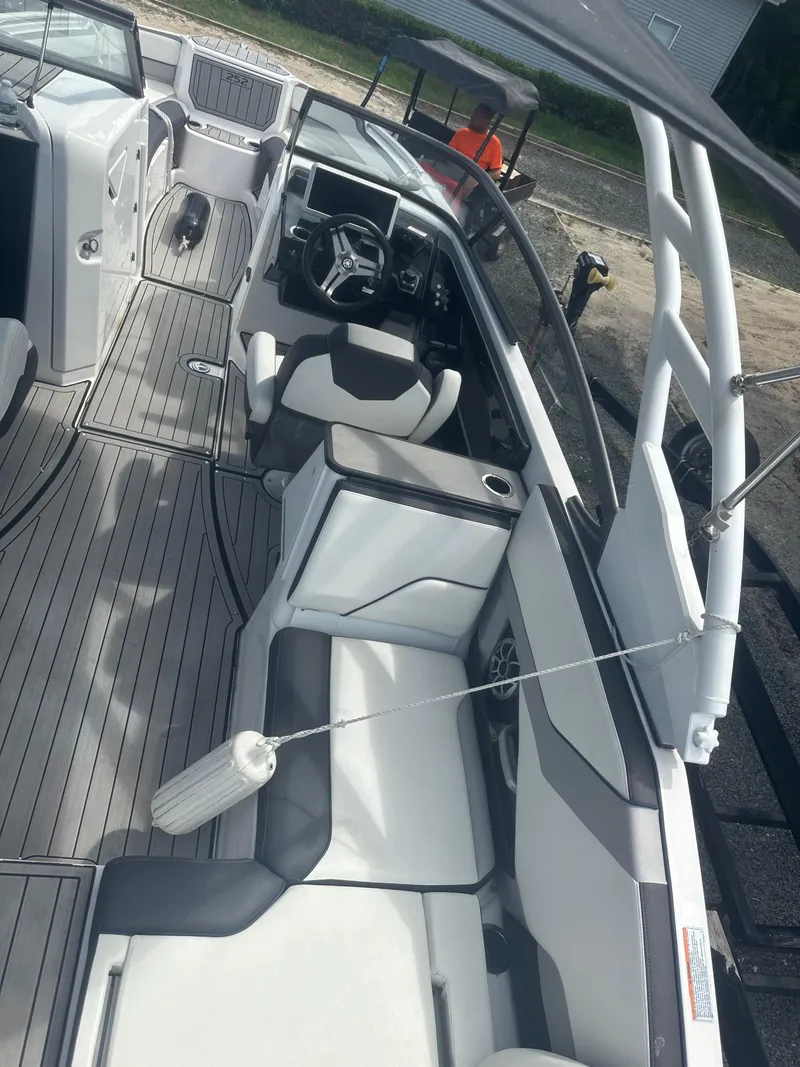 Slide: The Image of 2021 Yamaha Boats 252S interior with sleek seating and modern dashboard. - 17