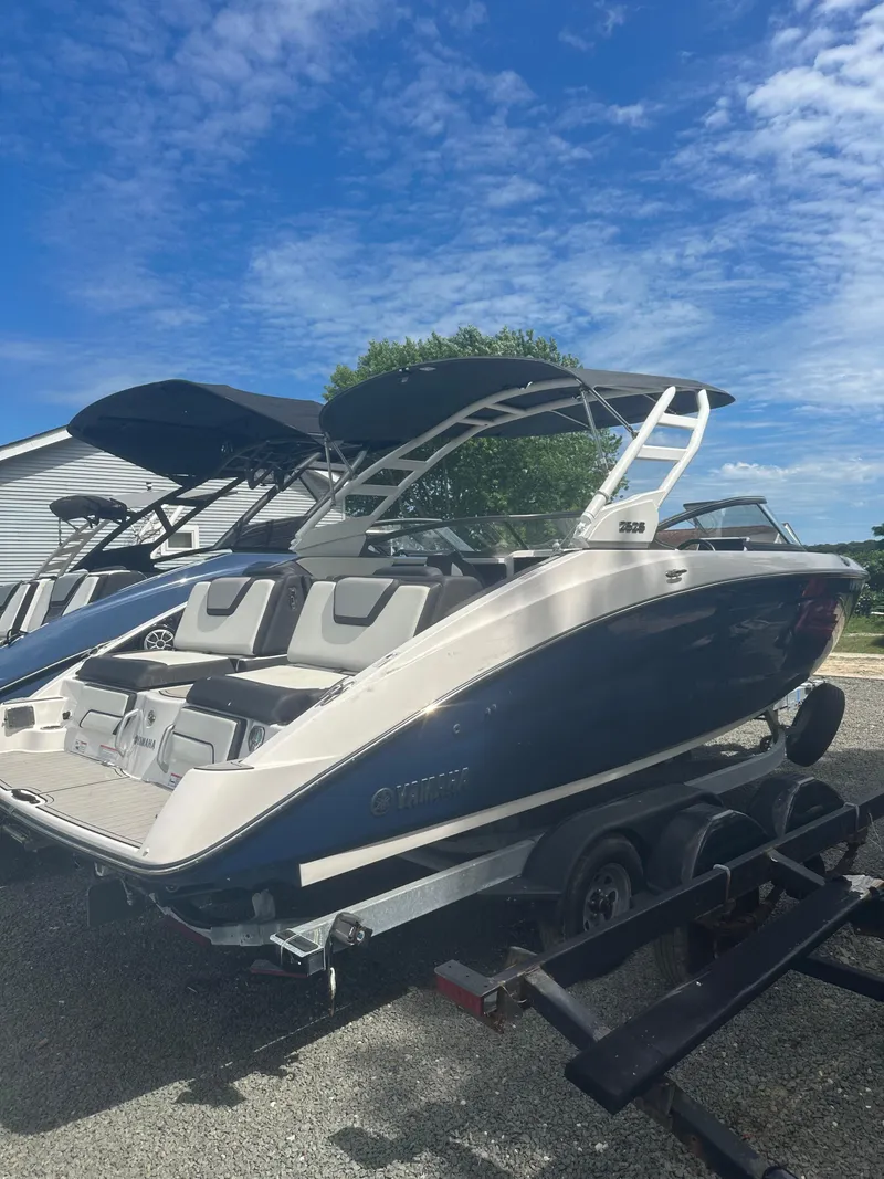 Slide: The Image of 2021 Yamaha Boats 252S on trailer under blue sky. - 3