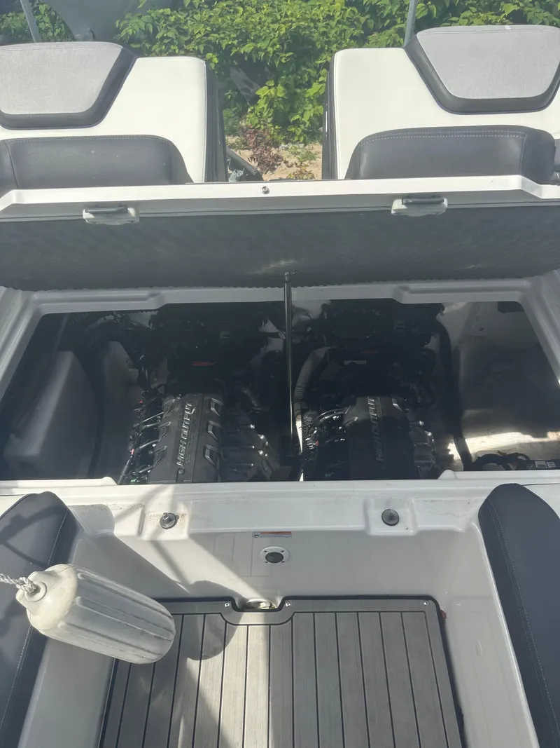 Slide: The Image of 2021 Yamaha Boats 252S engine compartment with dual engines, open hatch, and seating area. - 6