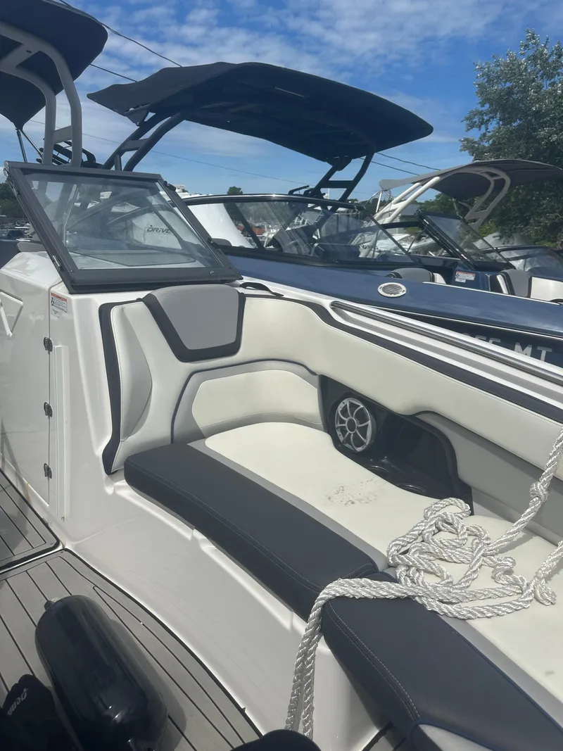 Slide: The Image of 2021 Yamaha Boats 252S interior with seating and speaker, under a clear blue sky. - 8