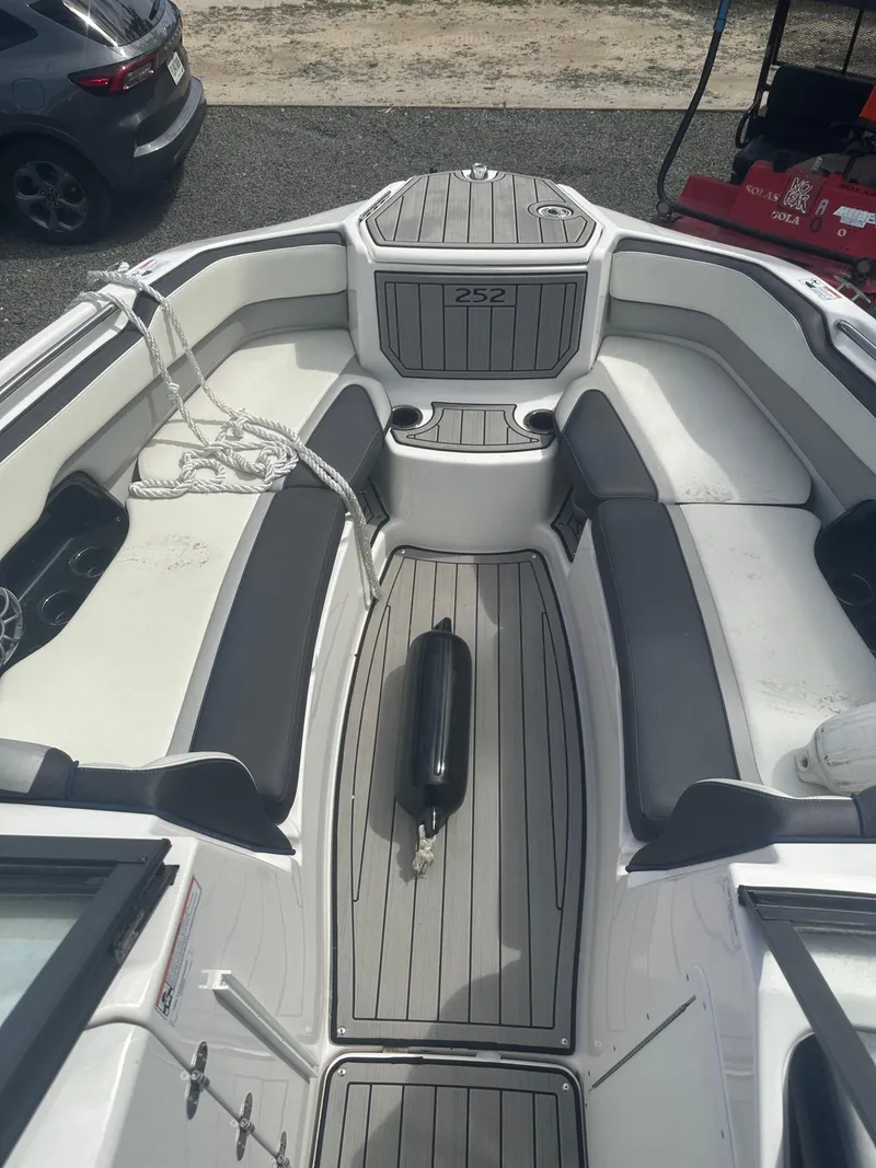 Slide: The Image of 2021 Yamaha Boats 252S interior with gray seating and deck, featuring a sleek design. - 9