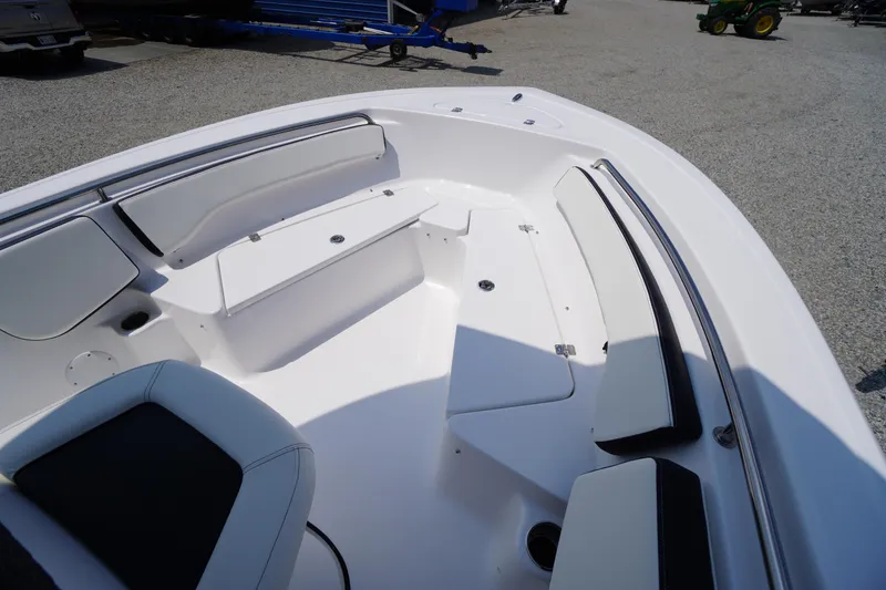 Slide: The Image of 2026 Tidewater 198 CC Adventure boat interior with cushioned seating and storage. - 10