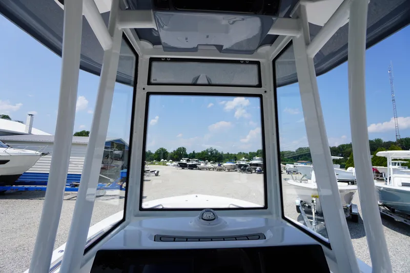 Slide: The Image of Interior view of 2026 Tidewater 198 CC Adventure boat, showcasing helm and windshield. - 17