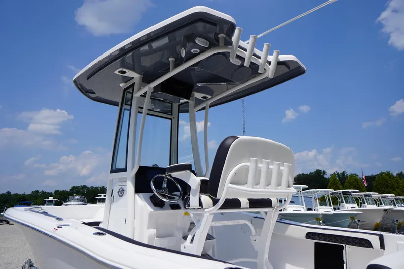 Slide: The Image of 2026 Tidewater 198 CC Adventure boat with T-top under a clear blue sky. - 18