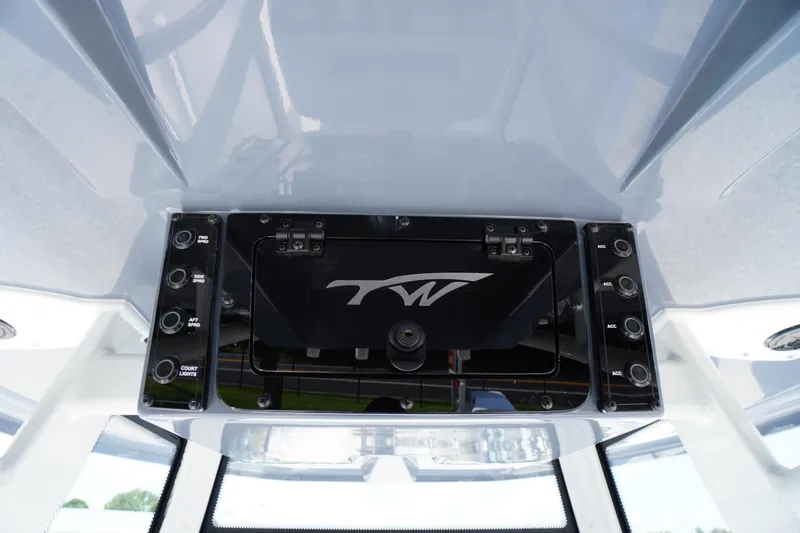 Slide: The Image of 2026 Tidewater 198 CC Adventure boat console with control panel and logo. - 19