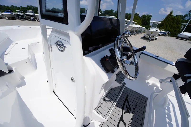 Slide: The Image of 2026 Tidewater 198 CC Adventure boat interior with steering wheel and console. - 21