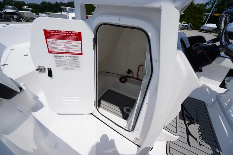 Slide: The Image of 2026 Tidewater 198 CC Adventure boat storage compartment with open door, showcasing interior details. - 22