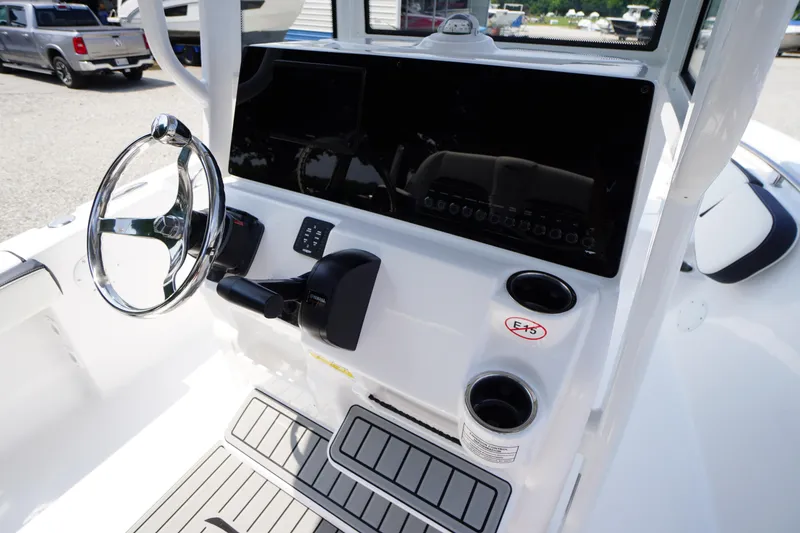 Slide: The Image of 2026 Tidewater 198 CC Adventure boat console with steering wheel and controls. - 25
