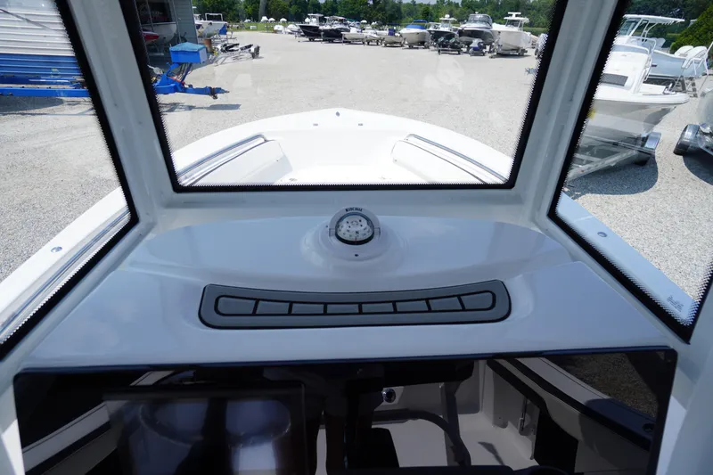 Slide: The Image of 2026 Tidewater 198 CC Adventure boat dashboard view at a marina. - 26