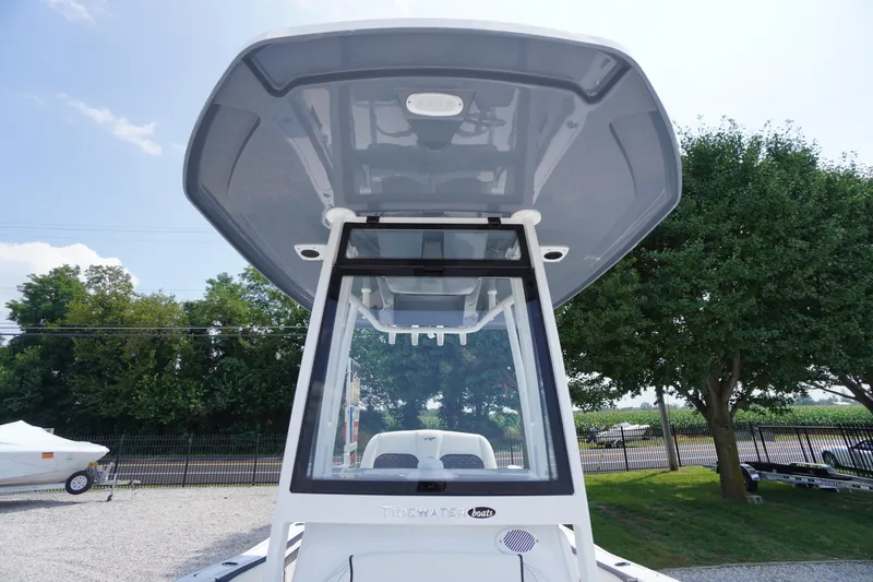 Slide: The Image of 2026 Tidewater 198 CC Adventure boat with T-top, parked outdoors. - 30