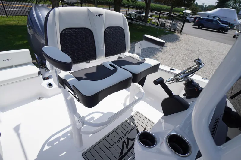 Slide: The Image of 2026 Tidewater 198 CC Adventure boat interior with dual seats and steering console. - 32