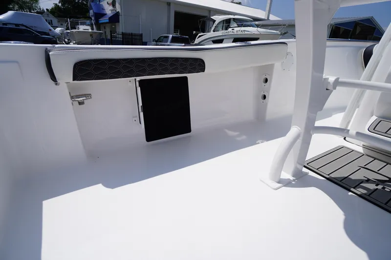 Slide: The Image of 2026 Tidewater 198 CC Adventure boat interior with seating and storage compartment. - 35