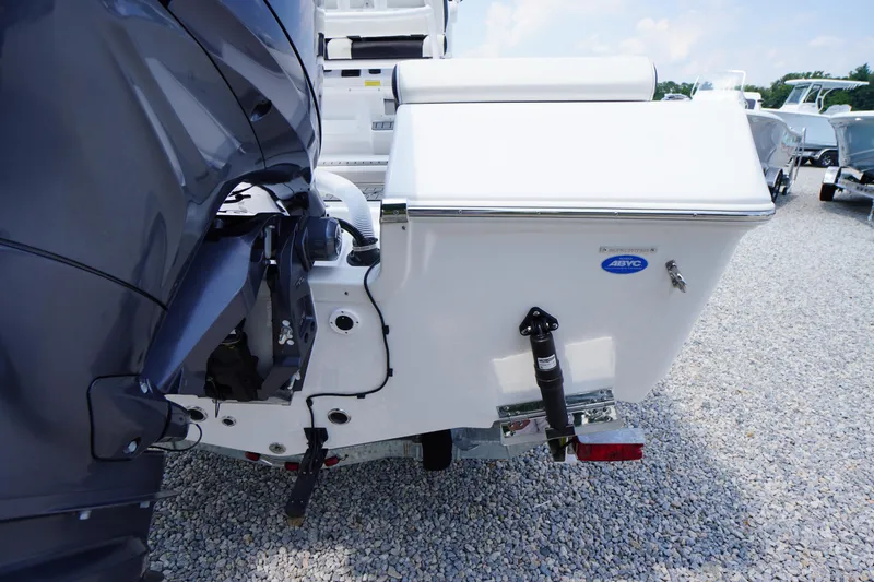 Slide: The Image of 2026 Tidewater 198 CC Adventure boat rear view with outboard motor on gravel. - 43