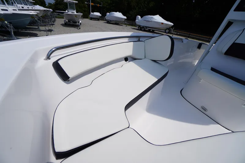 Slide: The Image of 2026 Tidewater 198 CC Adventure boat interior with white cushioned seating. - 7