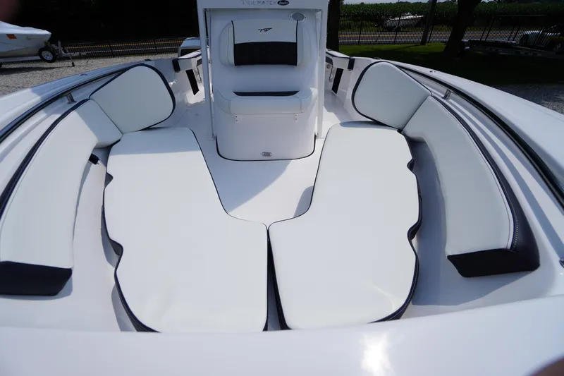 Slide: The Image of 2026 Tidewater 198 CC Adventure boat interior with white cushioned seating. - 9