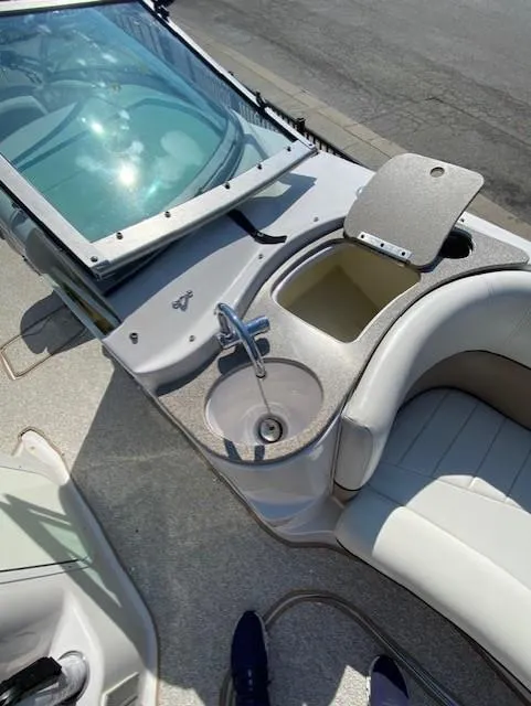 Slide: The Image of 2006 Four Winns 244 Funship boat interior with sink and seating area. - 10