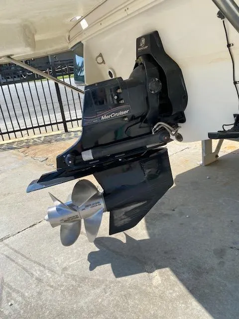 Slide: The Image of MerCruiser outdrive on a 2006 Four Winns 244 Funship boat, parked on concrete. - 12