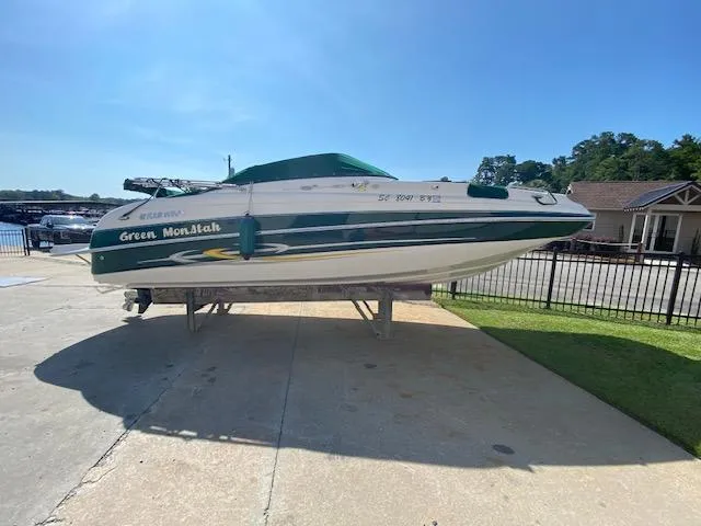 Slide: The Image of 2006 Four Winns 244 Funship boat on display outdoors, sunny day. - 16