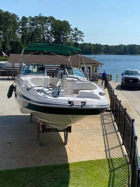 Slide: The Image of 2006 Four Winns 244 Funship boat on trailer by a lakeside dock. - 4