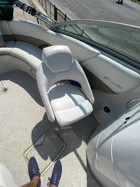 Slide: The Image of 2006 Four Winns 244 Funship boat interior with white seating and carpeted floor. - 7