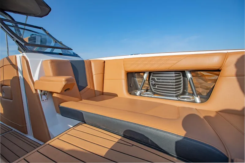 Slide: The Image of 2020 Nautique Super Air Nautique G25 interior with tan leather seating and speaker system. - 14