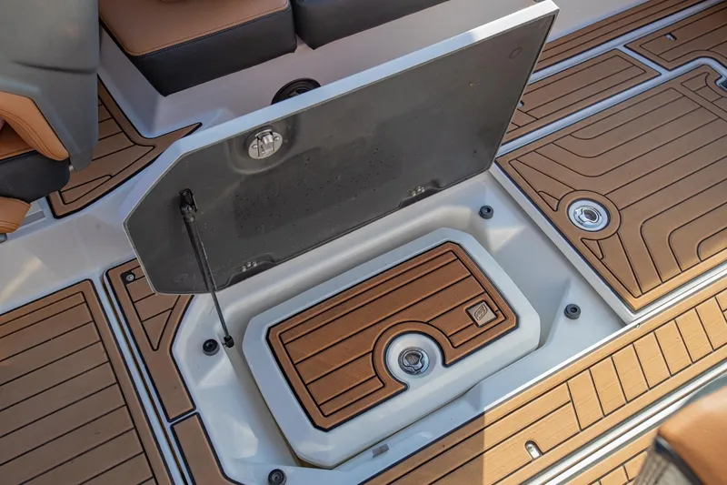 Slide: The Image of 2020 Nautique Super Air Nautique G25 storage compartment with teak-style flooring. - 17