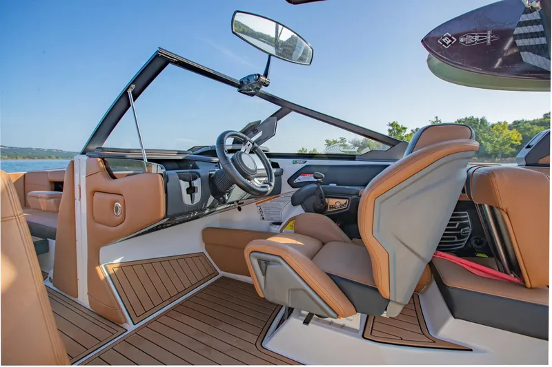 Slide: The Image of 2020 Nautique Super Air Nautique G25 interior with tan seats and sleek dashboard design. - 19