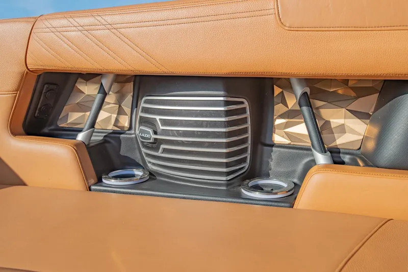 Slide: The Image of 2020 Nautique Super Air Nautique G25 interior with tan leather and JL Audio speaker. - 30