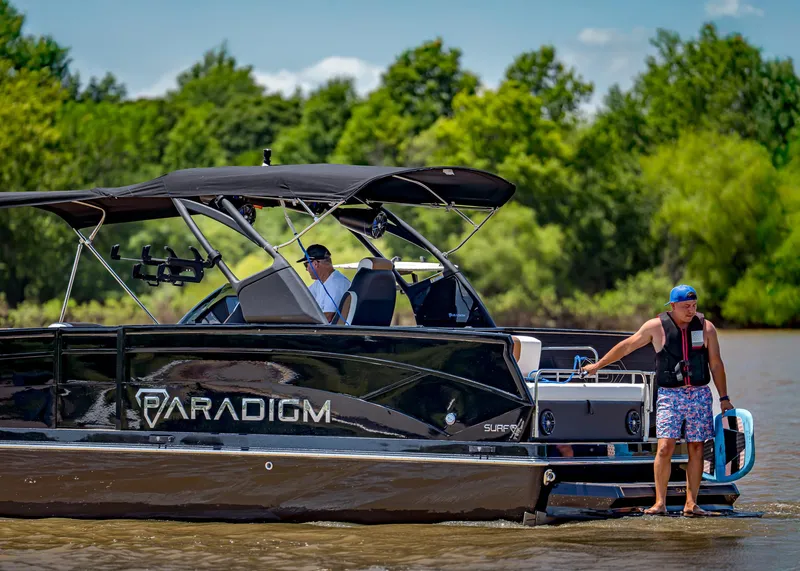 Slide: The Image of Pontoon boat Paradigm 236, 2025 model, cruising on a sunny lake with passengers. - 10