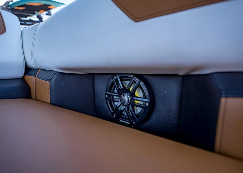 Slide: The Image of Boat interior with brown and white seating, featuring a built-in speaker. Paradigm 236, 2025 model. - 40