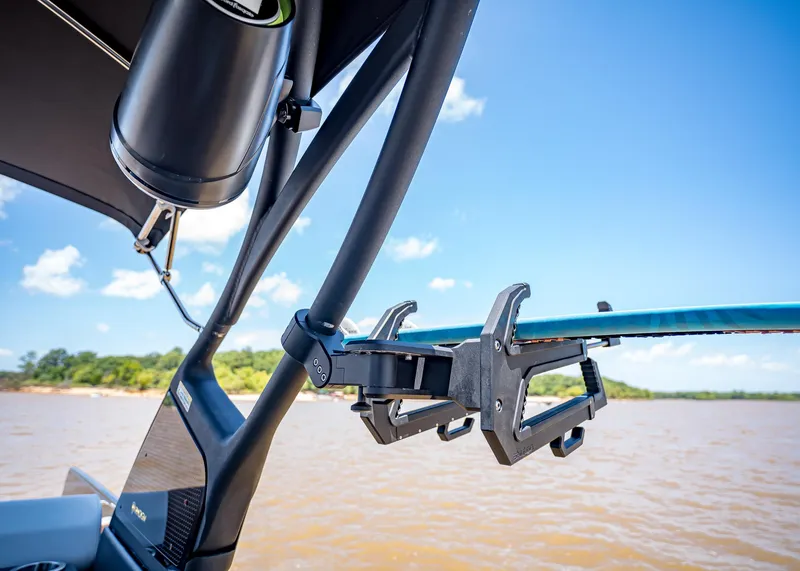 Slide: The Image of Wakeboard rack on a 2025 Paradigm 236 boat, with scenic lake view. - 41