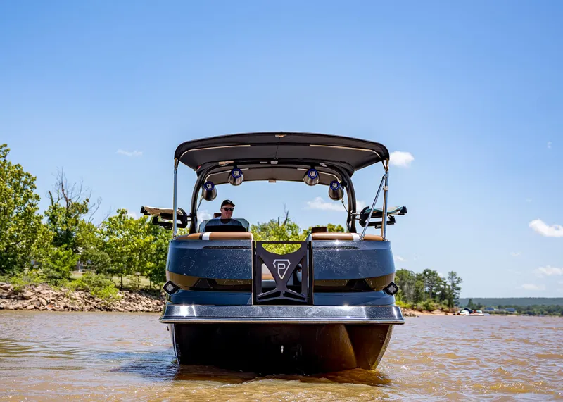 Slide: The Image of 2025 Paradigm 236 boat on a lake, clear sky, trees in the background. - 7