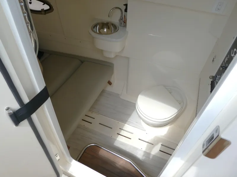 Slide: The Image of 2022 Scout 305 LXF boat interior with toilet and sink. - 15