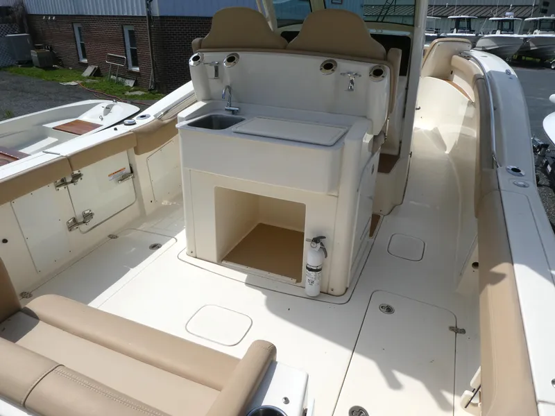 Slide: The Image of 2022 Scout 305 LXF boat interior with seating and sink area. - 5