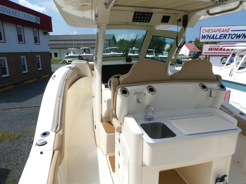 Slide: The Image of 2022 Scout 305 LXF boat interior with sink and seating at Chesapeake Whalertown. - 6