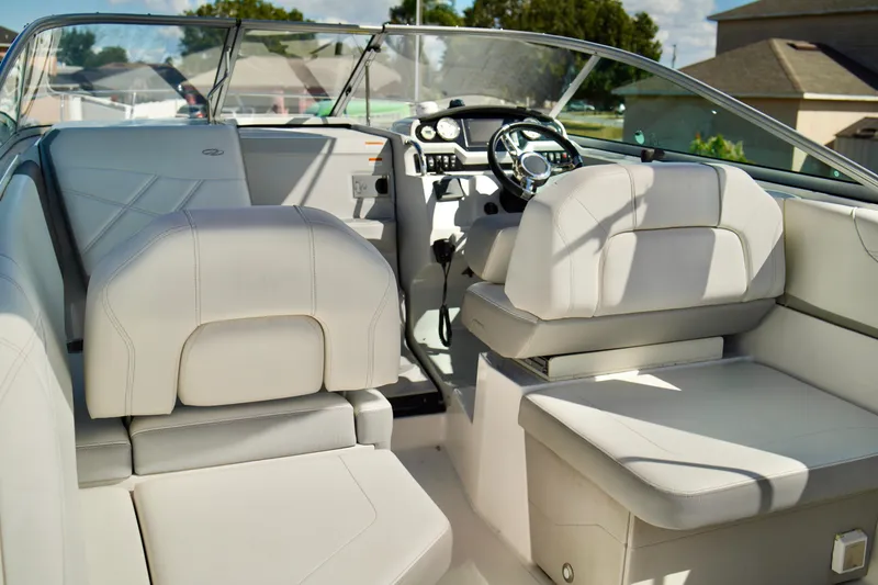 Slide: The Image of 2019 Regal 26 Express boat interior with white leather seating and modern dashboard. - 12